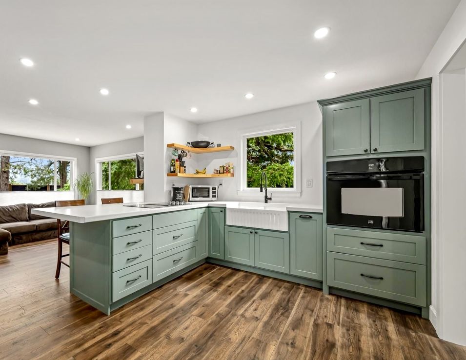 Renovated kitchen with green cabinets