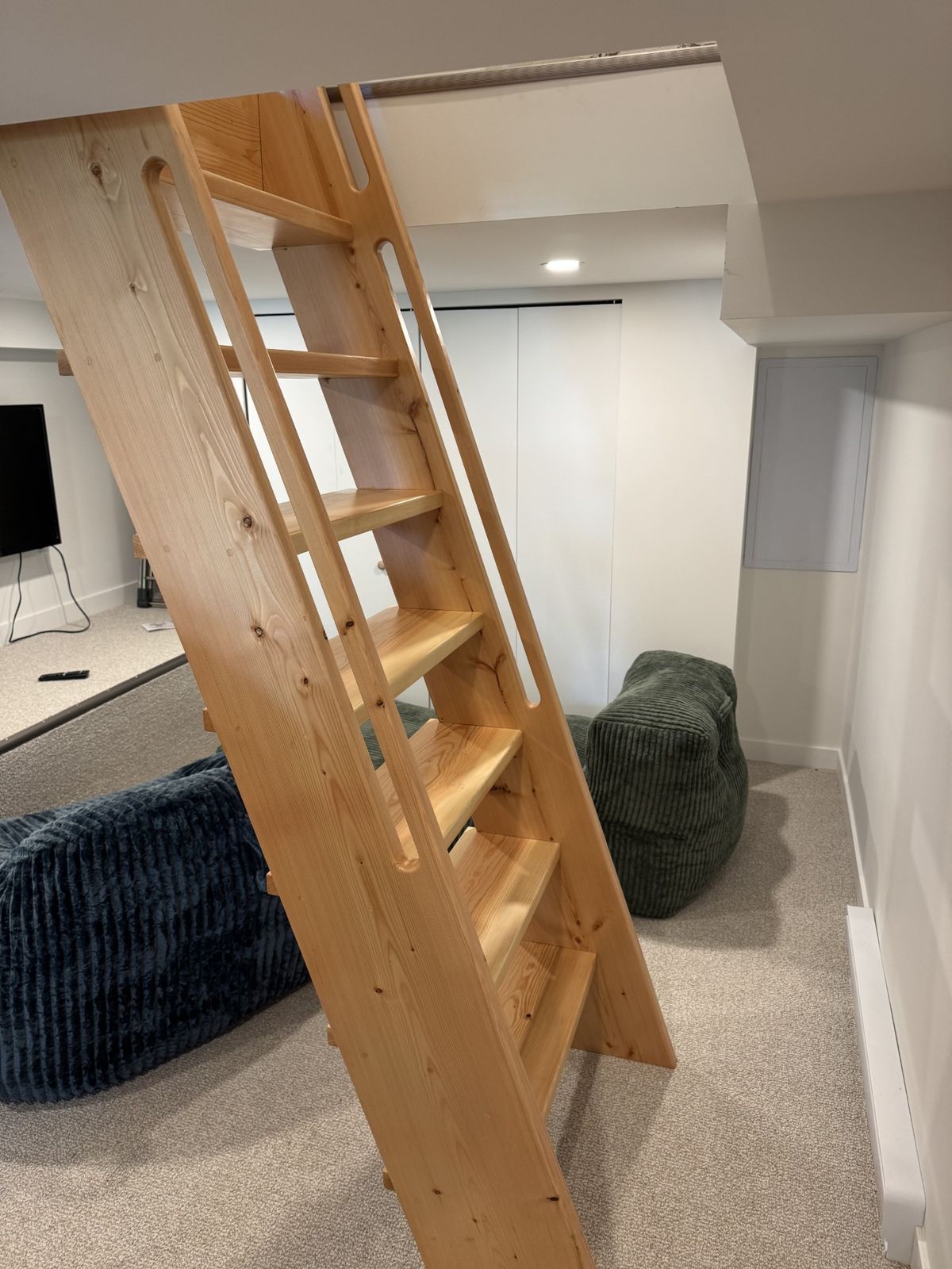 Custom wood ladder to a loft